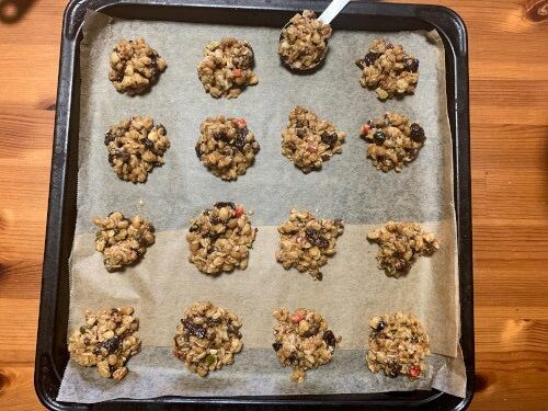 dropping a tablespoon of the granola dough to the baking sheet