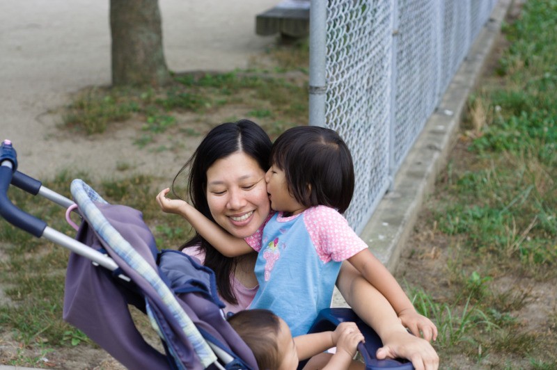 toddler kisses her mother with delight